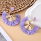Model wearing Earedge raffia fan earrings with casual outfit