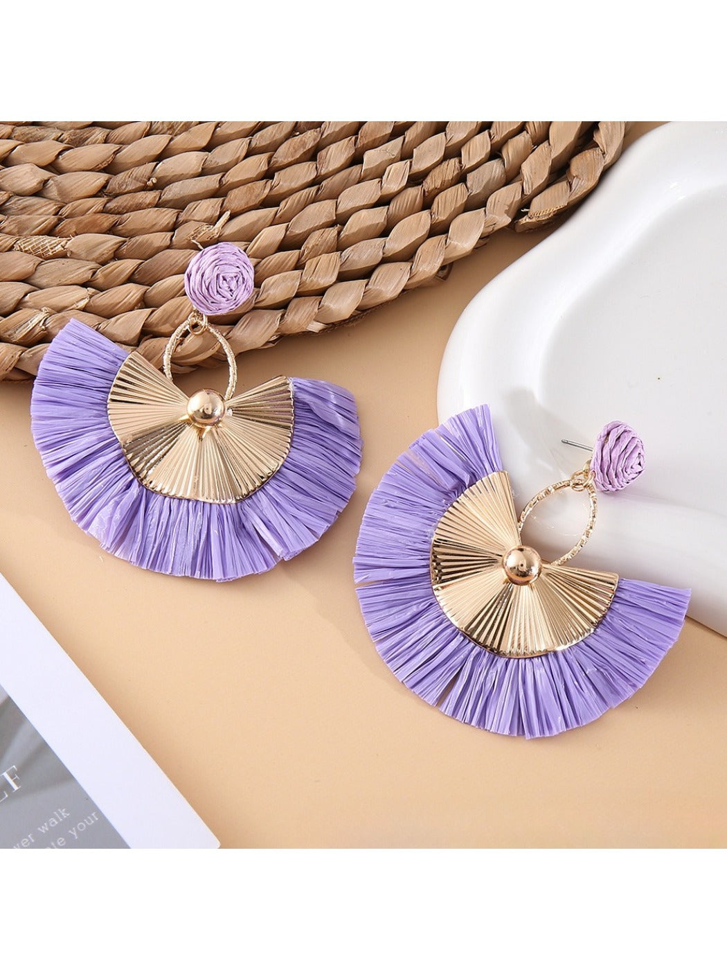 Model wearing Earedge raffia fan earrings with casual outfit