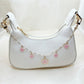 Minimalist cherry blossom pendant bag charm with delicate pink flowers on a silver chain