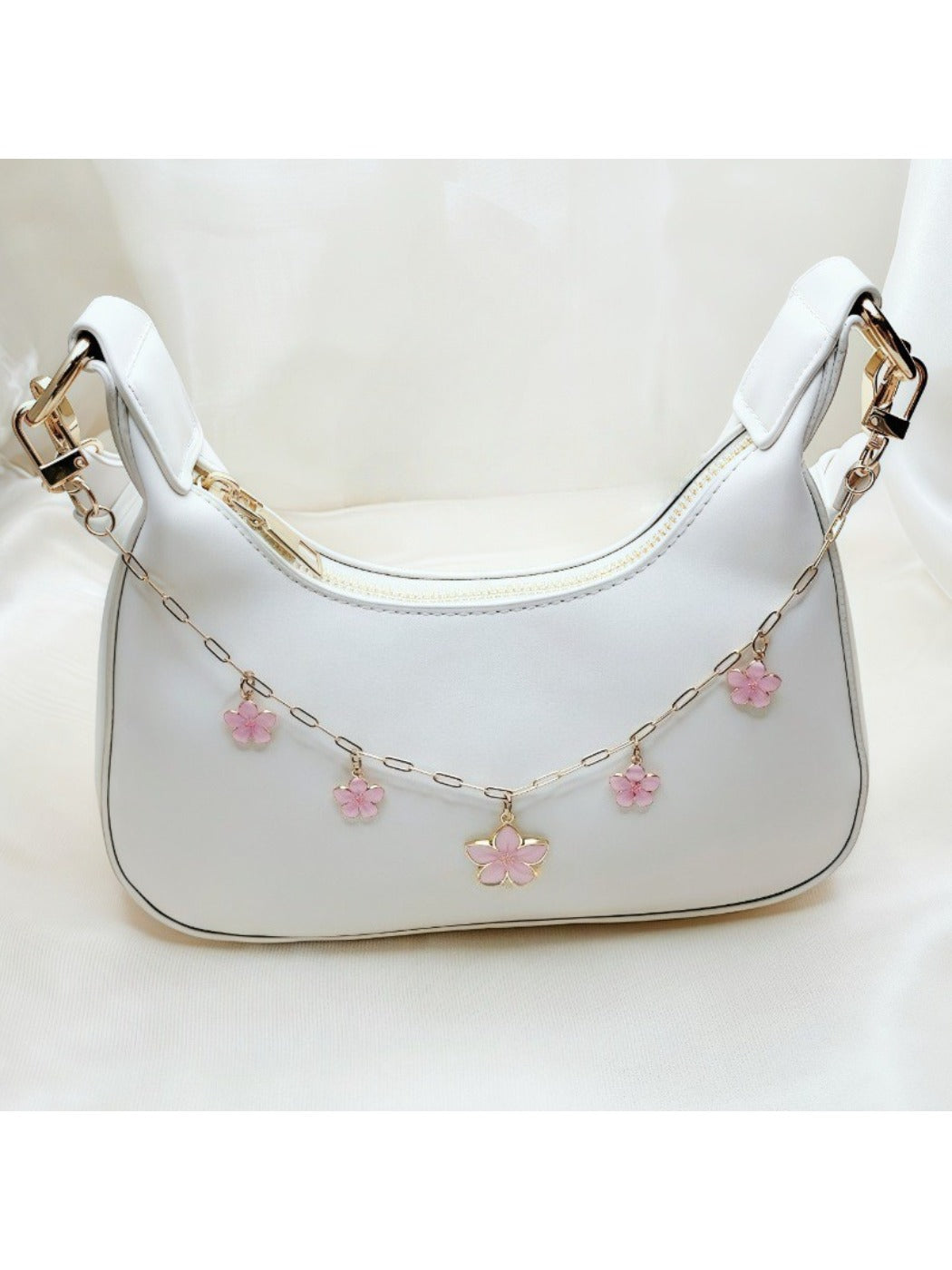 Minimalist cherry blossom pendant bag charm with delicate pink flowers on a silver chain