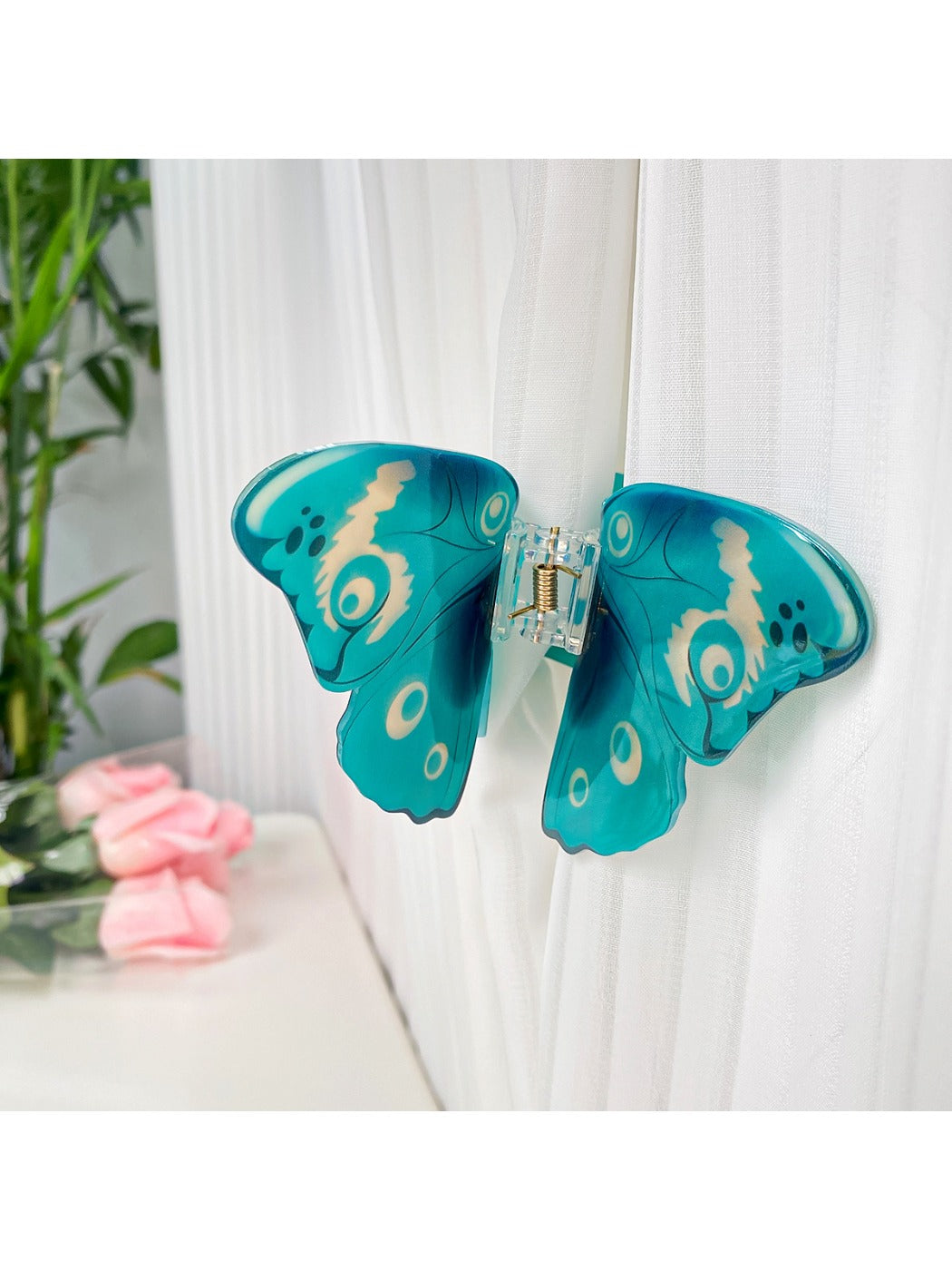 Beau butterfly hair claw clip with hair strands clipped inside