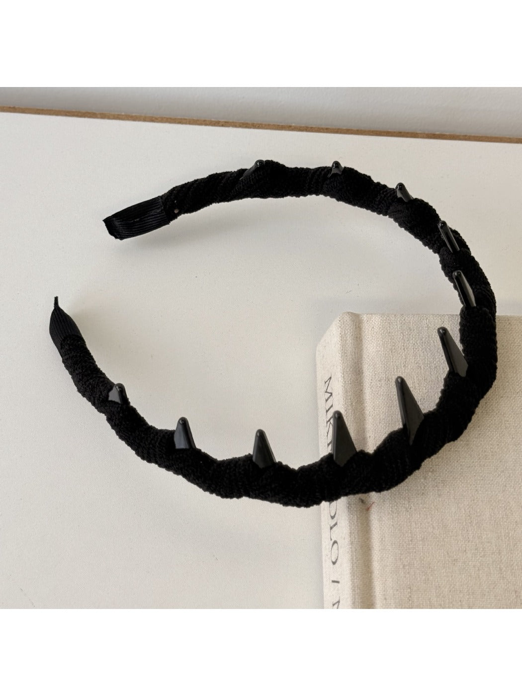 Pink corduroy headband displayed flat on white background showing full design