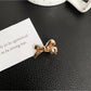 Beau classic bow hair clip resting on wooden surface with soft natural light