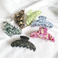 Beau vintage acetate claw clip in tortoiseshell pattern on white background