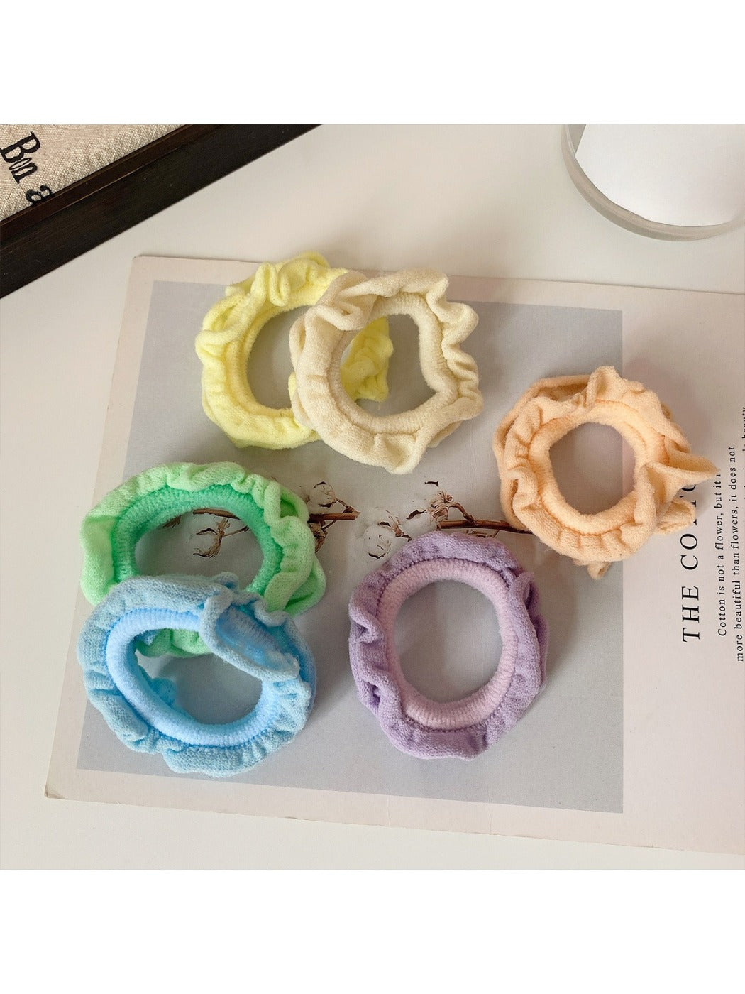 Ruffled hair ties in various colors stacked together showing texture and detail