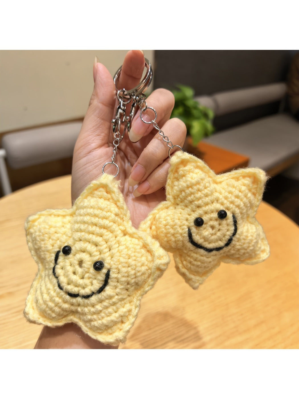 Close-up of the yarn star charm showing detailed stitching and texture