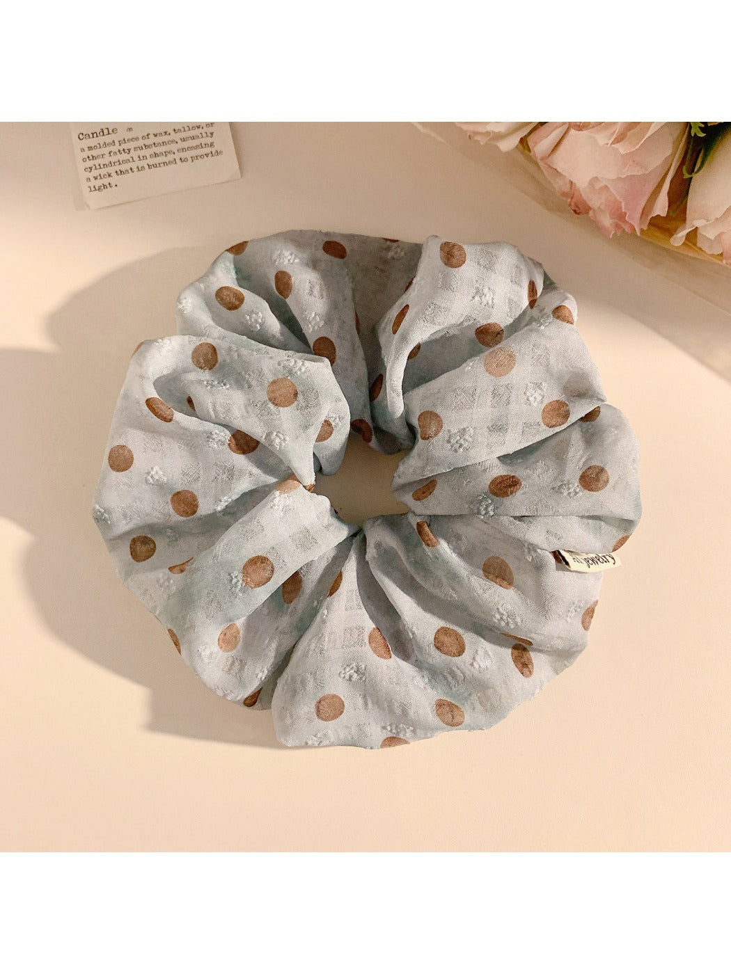Multiple Gifty polka dot scrunchies stacked together showing pattern and texture