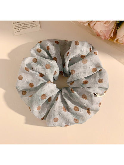 Multiple Gifty polka dot scrunchies stacked together showing pattern and texture