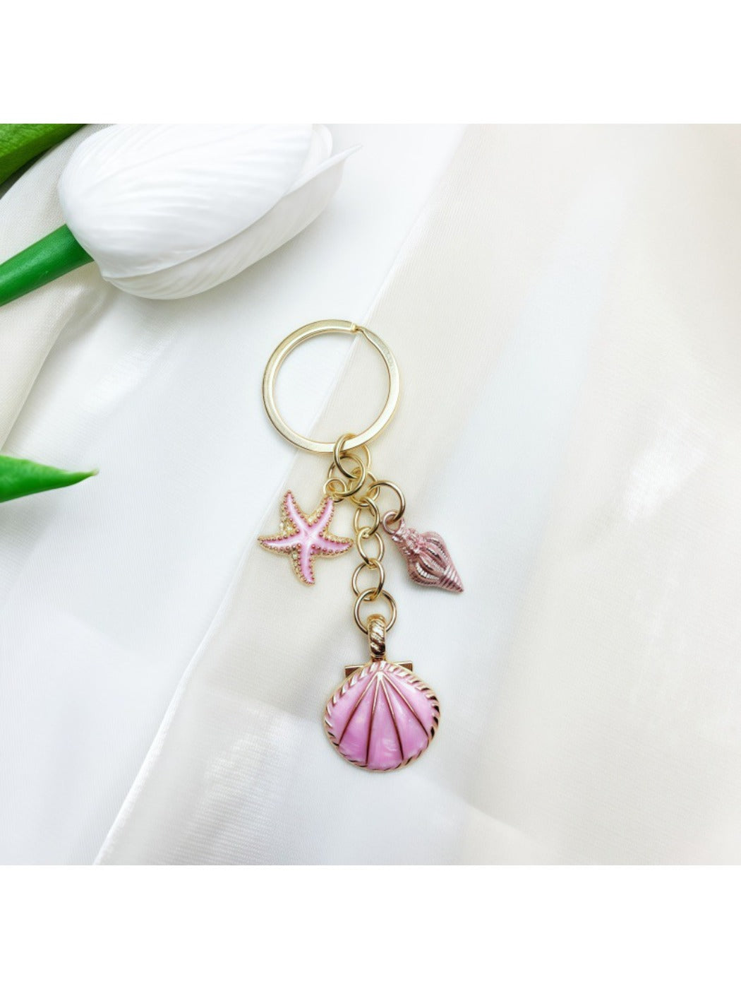 Keypus pendant keychain with ocean wave design against a white background