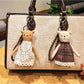 Side view of cartoon bear charm keychain highlighting its rounded ears and smooth finish