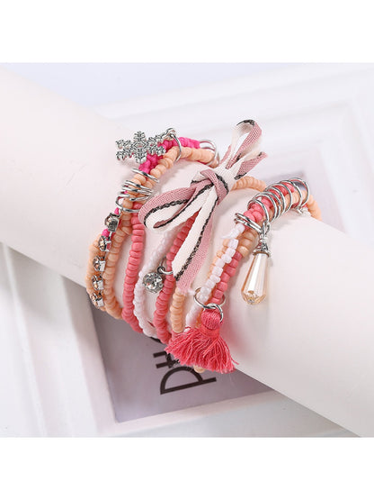 Detailed shot of Lovra bracelet clasp and bead strands on white surface