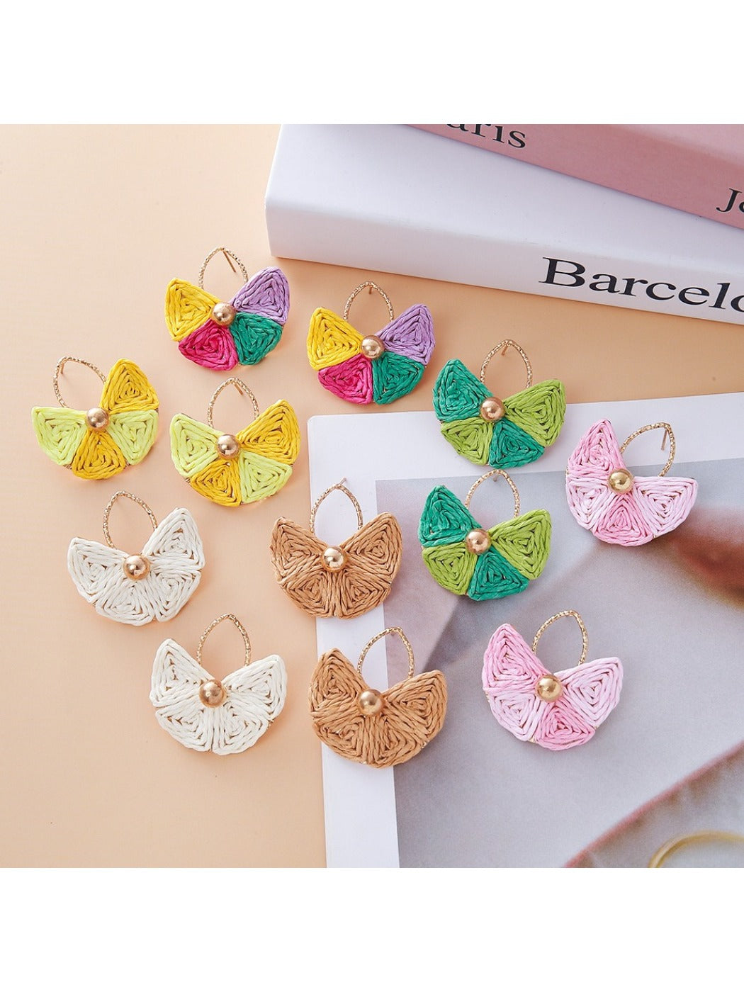 Close-up of vintage fan shaped raffia drop earrings on white background