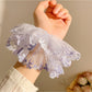 Model wearing Gifty floral ruched scrunchie in hair with loose waves