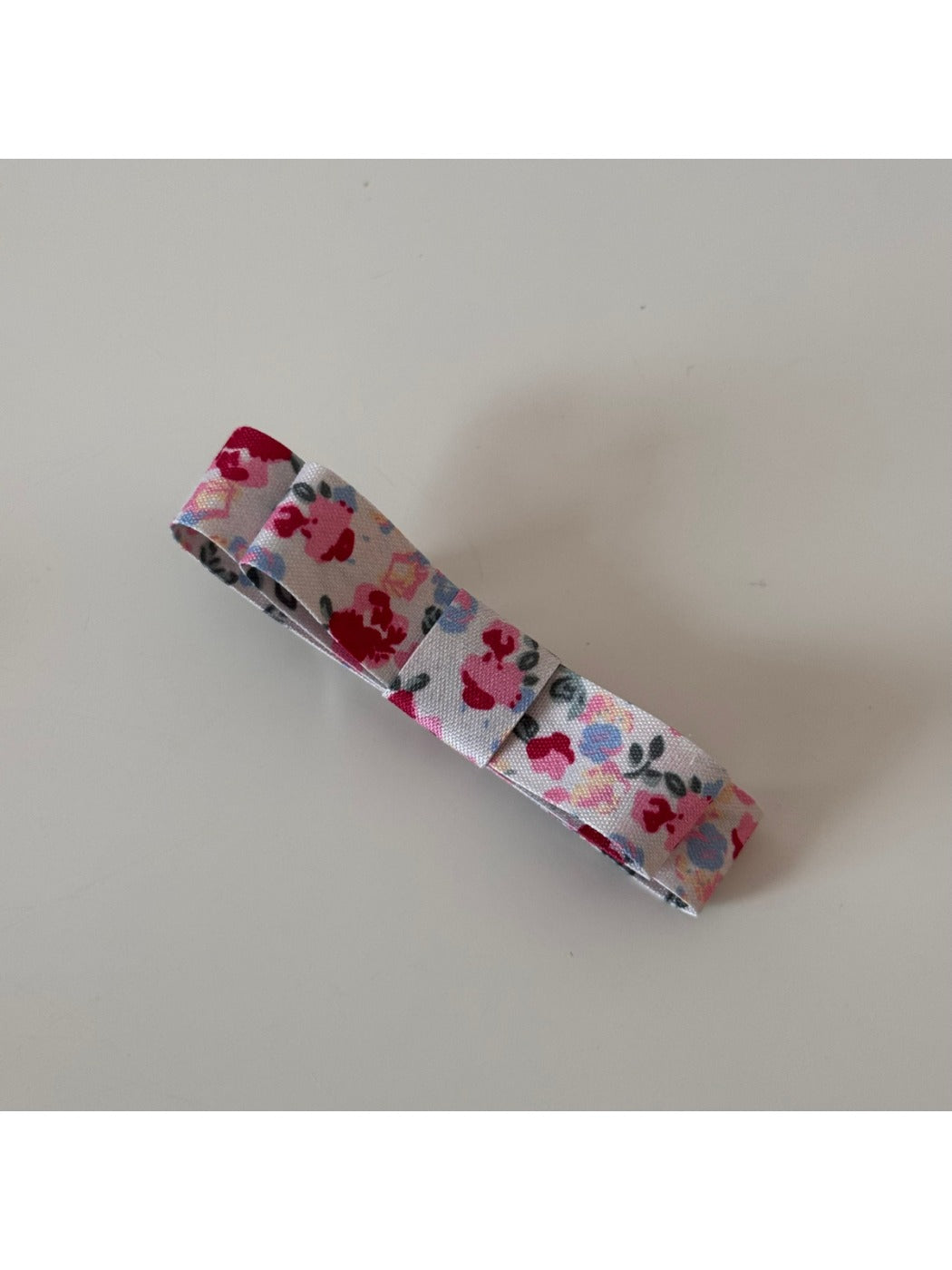 Beau hair clip displayed with matching pink floral accessories