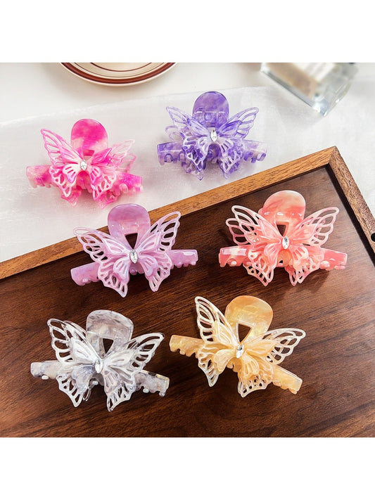 Beau hair claw clip with elegant butterfly decoration on a white background