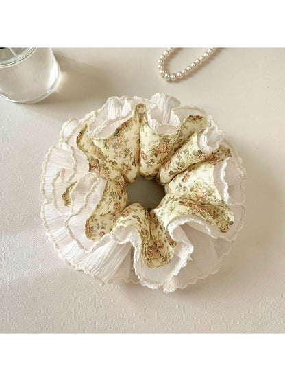 Gifty vintage floral ruched scrunchie styled in a woman's hair with loose curls