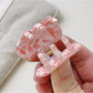 Beau dreamy cloud hair claw clip held in hand to show size and scale
