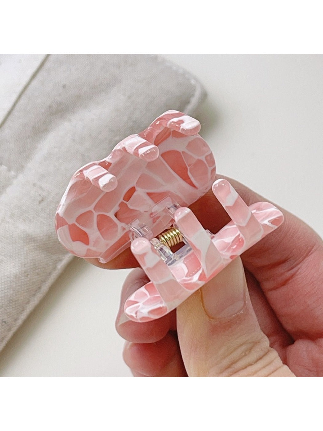 Beau dreamy cloud hair claw clip held in hand to show size and scale