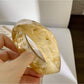 Lovra vintage ombre wide cuff bangle bracelet displayed on black stand