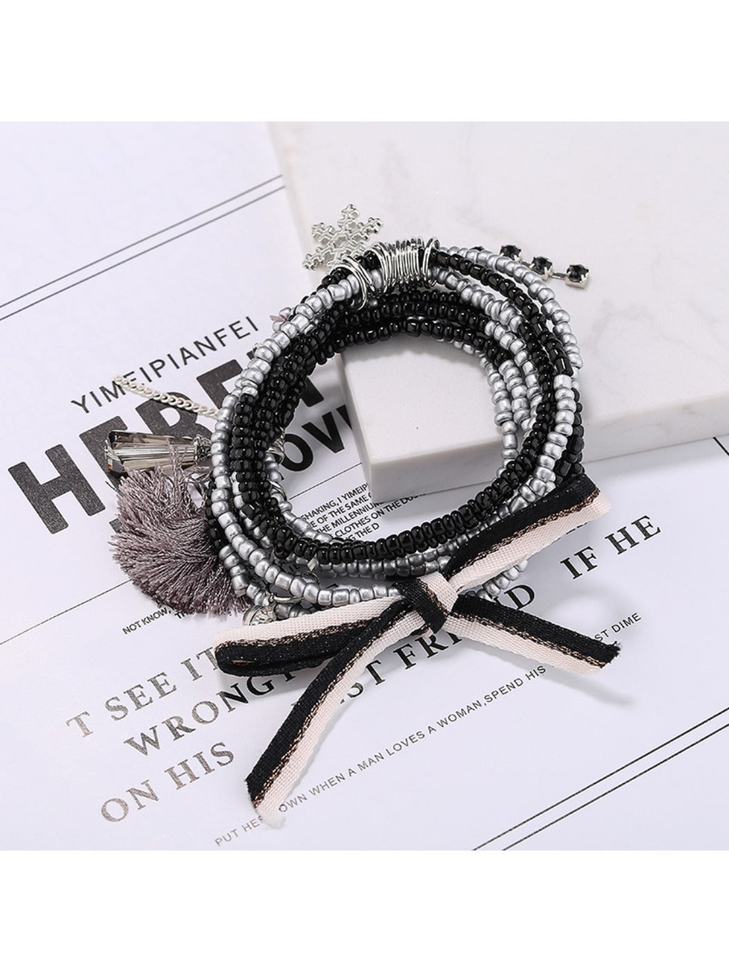 Lovra bracelet with mixed gold and black beads arranged in multiple strands