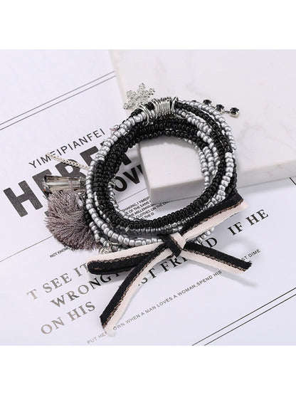 Lovra bracelet with mixed gold and black beads arranged in multiple strands