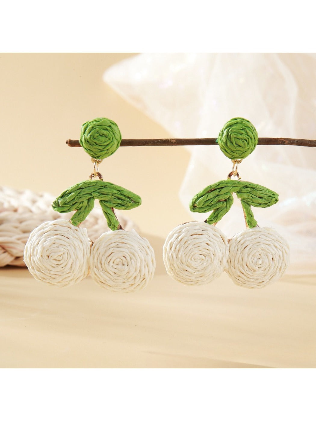 Pair of lightweight raffia cherry earrings with red woven cherries and green leaves
