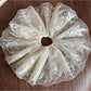 Gifty delicate lace scrunchie laid flat with soft shadows