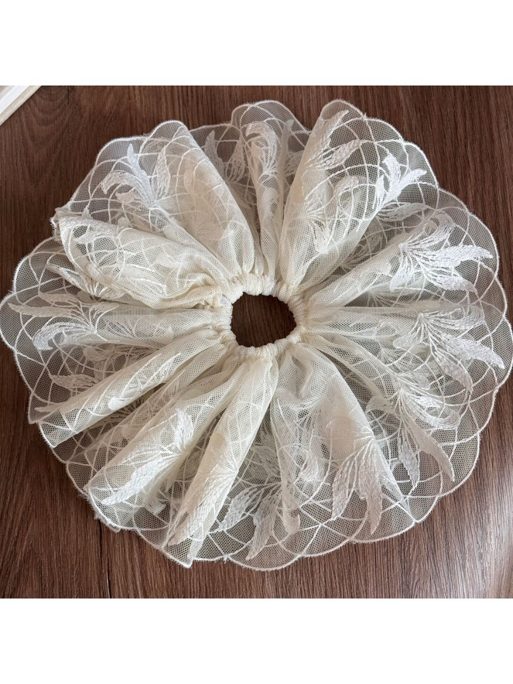 Gifty delicate lace scrunchie laid flat with soft shadows