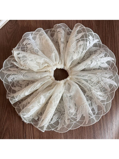 Gifty delicate lace scrunchie laid flat with soft shadows