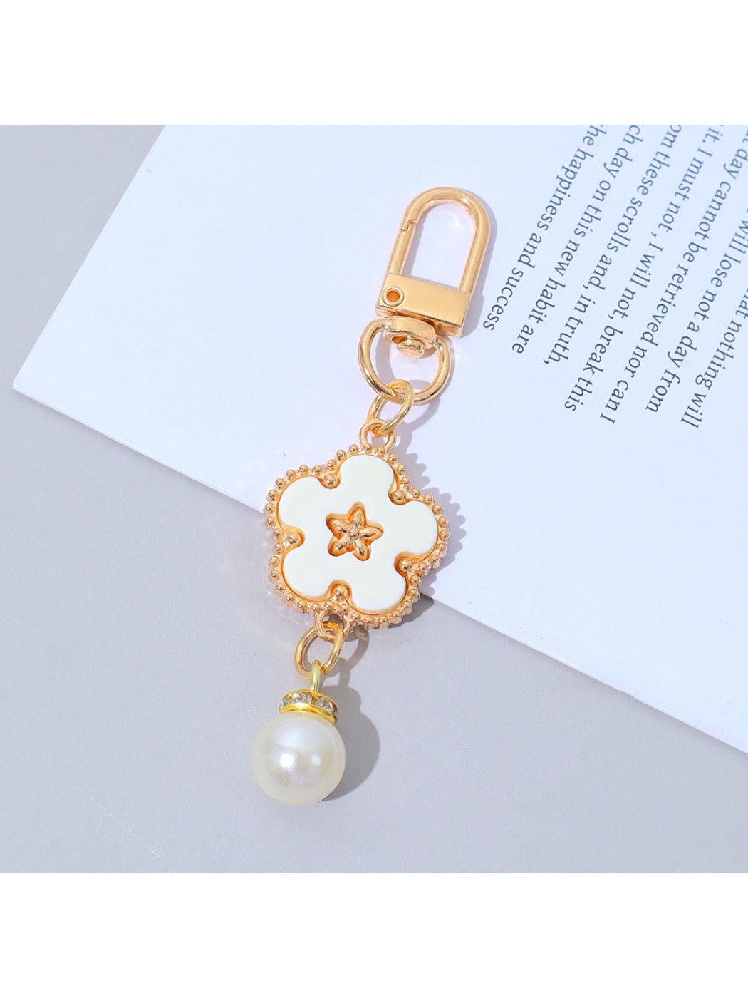 Flower charm keychain with vibrant colors and silver keyring on a wooden surface
