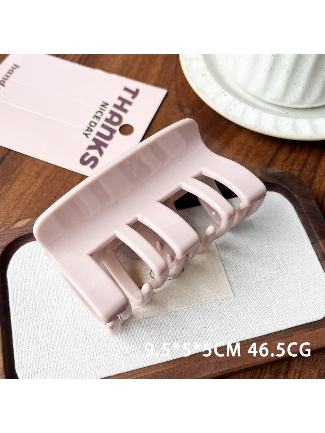 Beau plastic square claw clip positioned diagonally on white surface