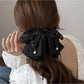 Side view of Beau bow accented hair claw clip highlighting curved teeth