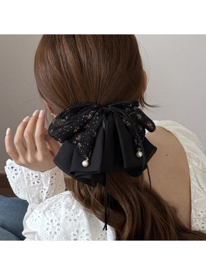 Side view of Beau bow accented hair claw clip highlighting curved teeth