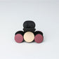 Beau hair clip displayed on a white surface with soft lighting