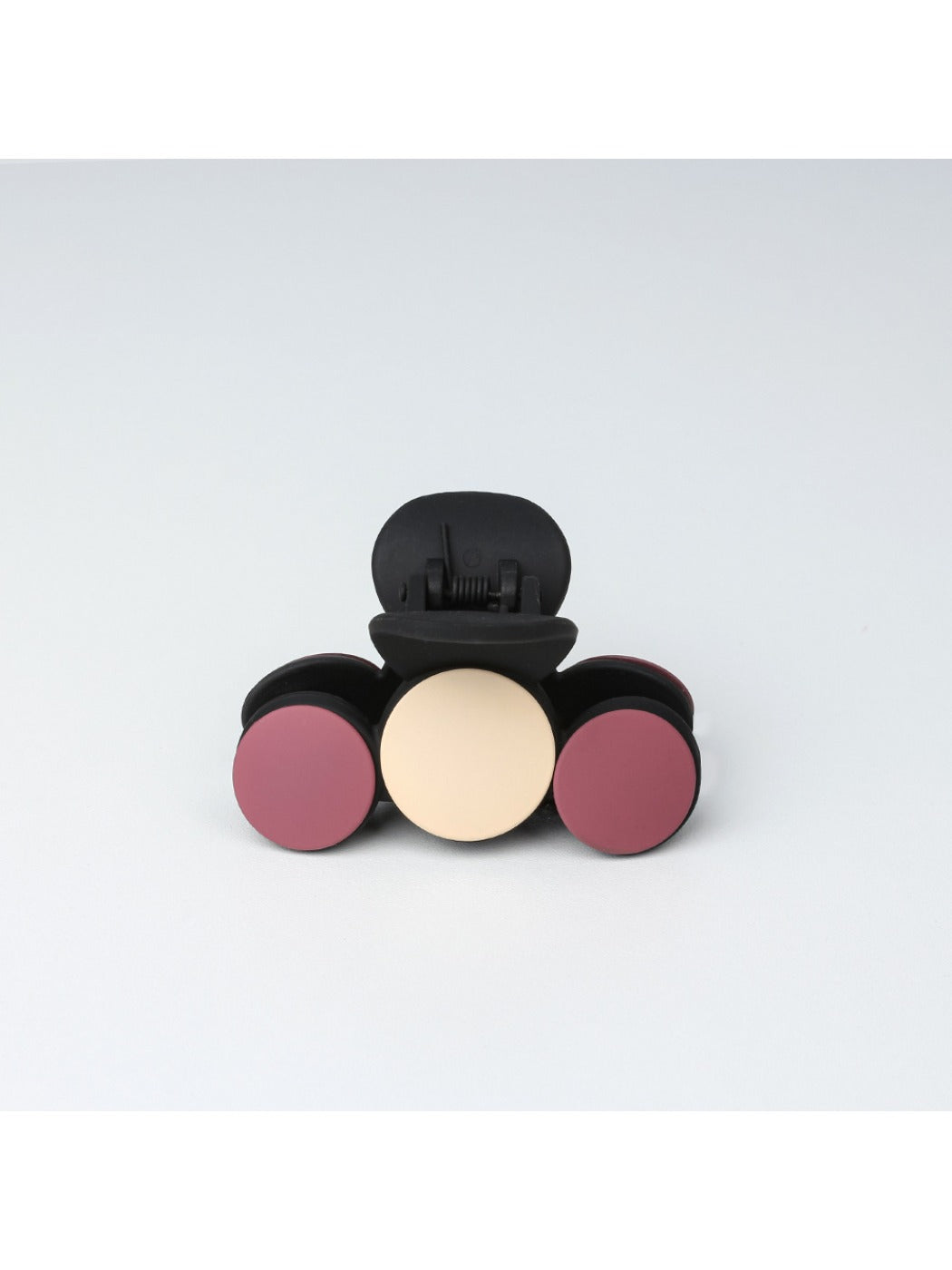 Beau hair clip displayed on a white surface with soft lighting