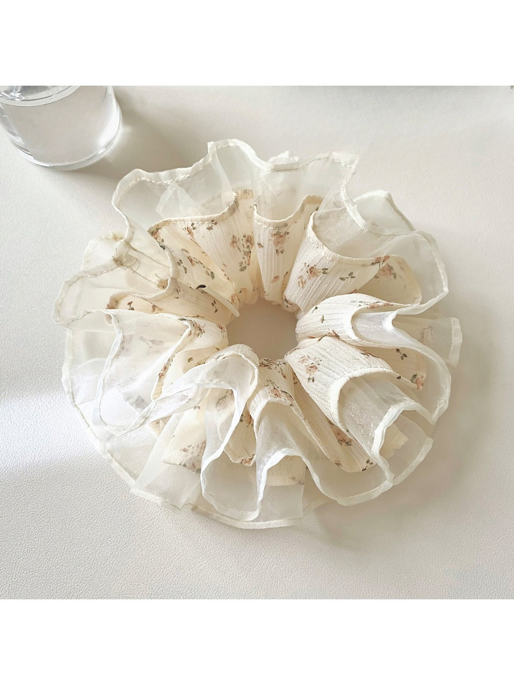 Gifty scrunchie styled on a wrist, highlighting its delicate floral tulle design