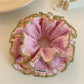Pink double scrunchie with lace trim on a white background