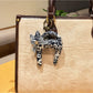 Keypus cartoon cat charm keychain shown with other colorful keychains on a key holder