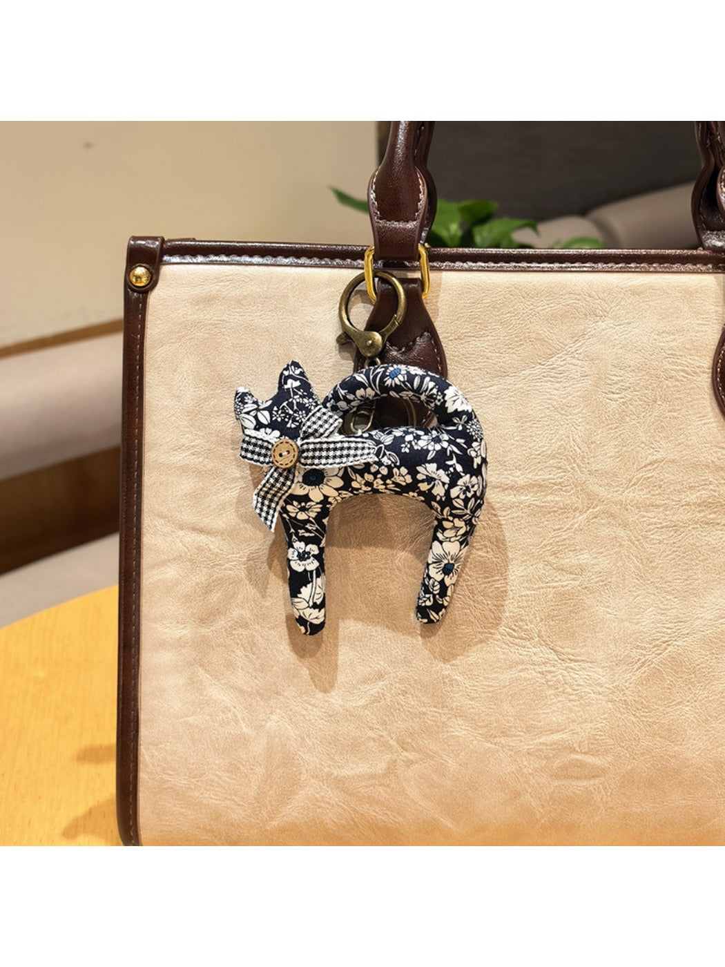 Keypus cartoon cat charm keychain shown with other colorful keychains on a key holder