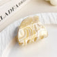 Beau half moon claw clip with glossy finish and mixed colors