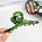 Beau hair claw clip open to display spring mechanism and teeth