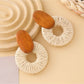 Earedge round drop earrings worn on a model's ear with natural lighting