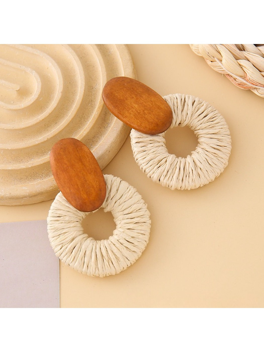 Earedge round drop earrings worn on a model's ear with natural lighting