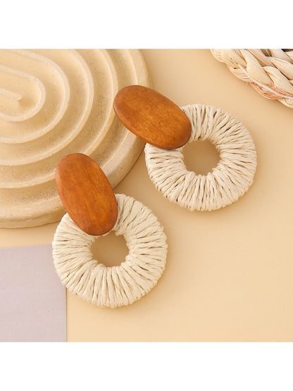 Earedge round drop earrings worn on a model's ear with natural lighting
