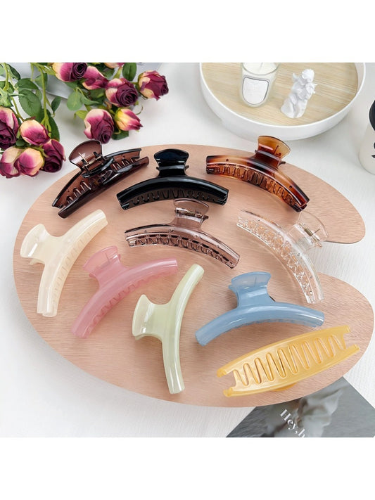 Pastel curved claw hair clip in soft pink and lavender tones on white background