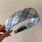 Gifty headband folded to display pattern and stitching details on fabric