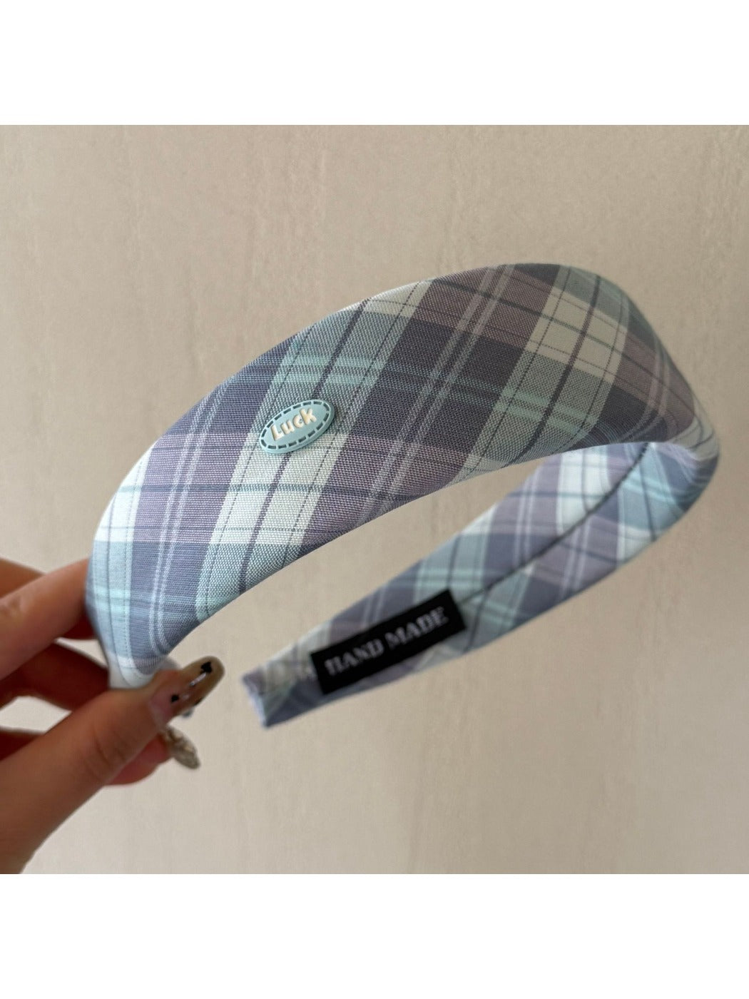 Gifty headband folded to display pattern and stitching details on fabric