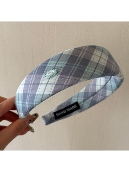 Gifty headband folded to display pattern and stitching details on fabric