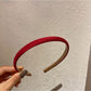 Candy color satin headband in pastel yellow displayed flat