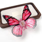 Beau butterfly hair claw clip in soft focus with blurred background